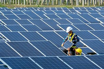 men working on solar panel